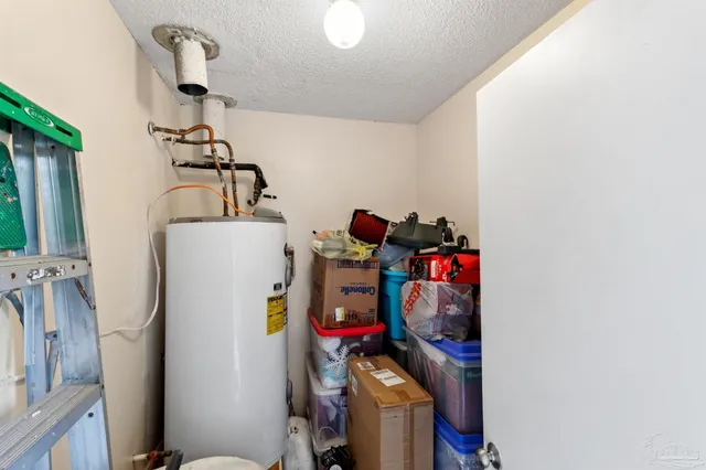 a view of a storage & utility room with refrigerator and toys