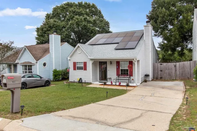a front view of a house with a yard table and chairs