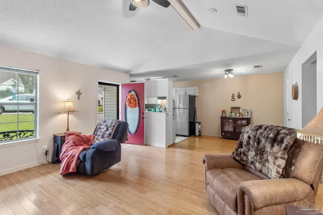 a living room with furniture gym equipment and a large window