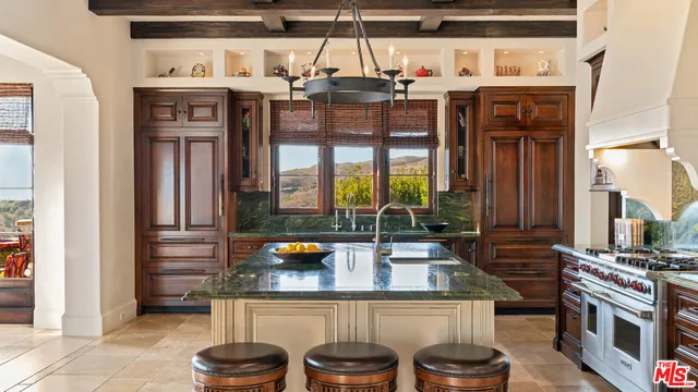 a kitchen with a stove and a refrigerator