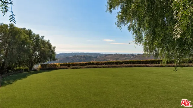 a view of a lake with houses in the back