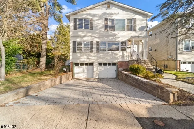 a front view of a house with a garden and patio
