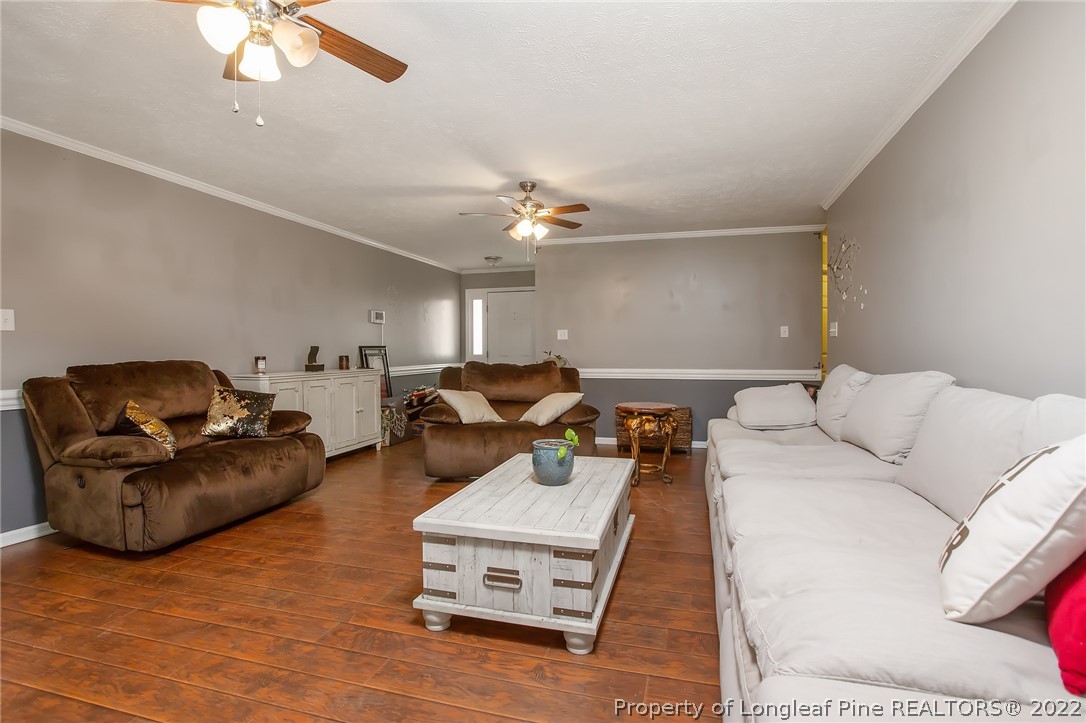 7156 Rockfish Road Raeford, NC 28376 - Photo 14 of 27 a living room with furniture and a chandelier