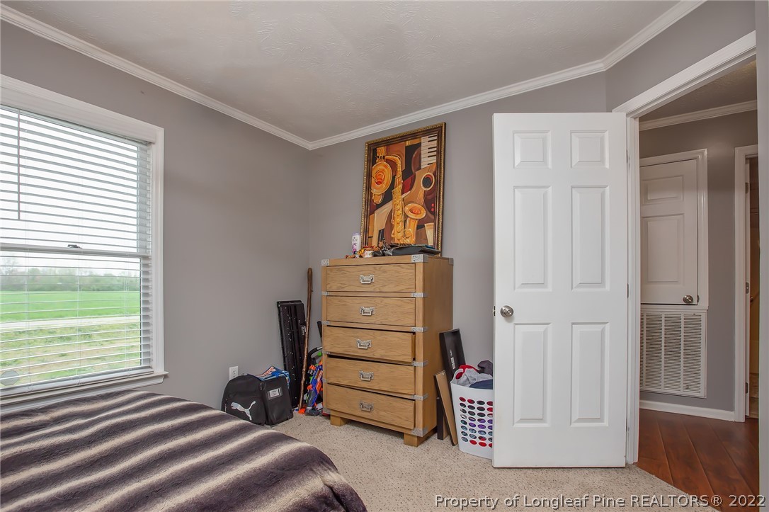 7156 Rockfish Road Raeford, NC 28376 - Photo 22 of 27 a bedroom with a bed and a window
