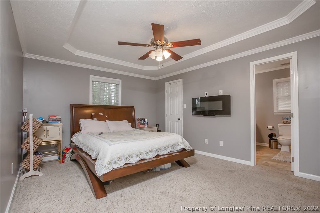 7156 Rockfish Road Raeford, NC 28376 - Photo 23 of 27 a bedroom with a bed and a ceiling fan