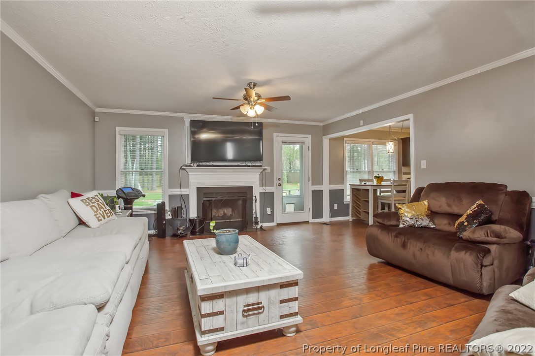 7156 Rockfish Road Raeford, NC 28376 - Photo 8 of 27 a living room with furniture fireplace and flat screen tv