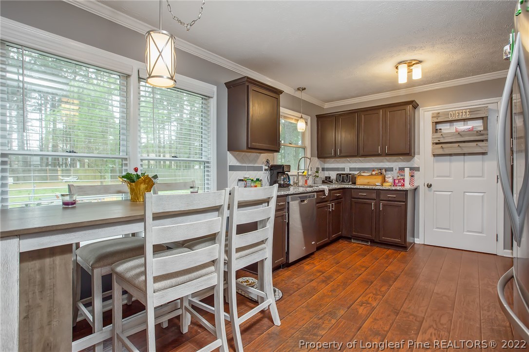 7156 Rockfish Road Raeford, NC 28376 - Photo 10 of 27 a kitchen with a sink cabinets and window