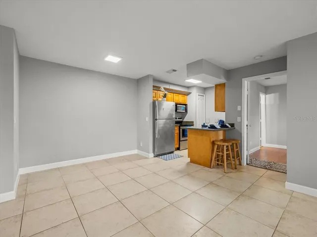 a kitchen with stainless steel appliances a refrigerator and microwave