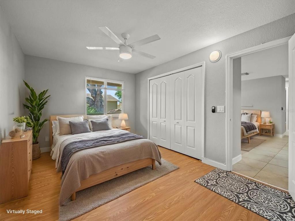 230 Thorntree Place, Unit 230 Brandon, FL 33510 - Photo 27 of 49 a bedroom with a large bed and a chandelier