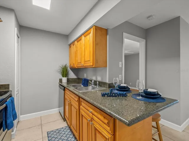 a kitchen with sink a window and cabinets