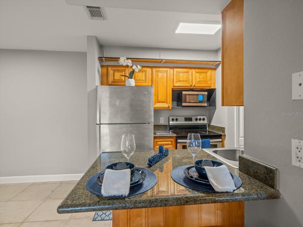 230 Thorntree Place, Unit 230 Brandon, FL 33510 - Photo 8 of 49 a kitchen with sink a refrigerator and a stove