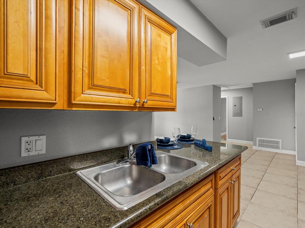 230 Thorntree Place, Unit 230 Brandon, FL 33510 - Photo 9 of 49 a kitchen with stainless steel appliances granite countertop a sink stove and cabinets