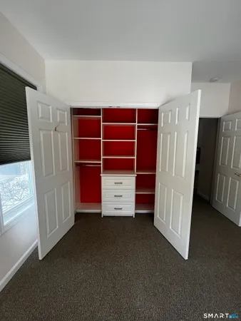 a view of an empty room with a cabinet