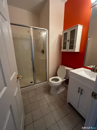 a bathroom with a toilet and a shower