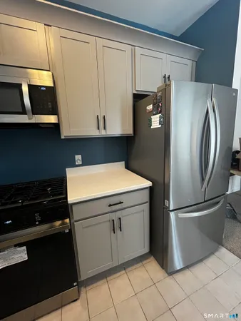 a kitchen with stainless steel appliances a refrigerator and cabinets