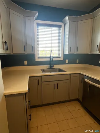 a kitchen with a sink cabinets and window
