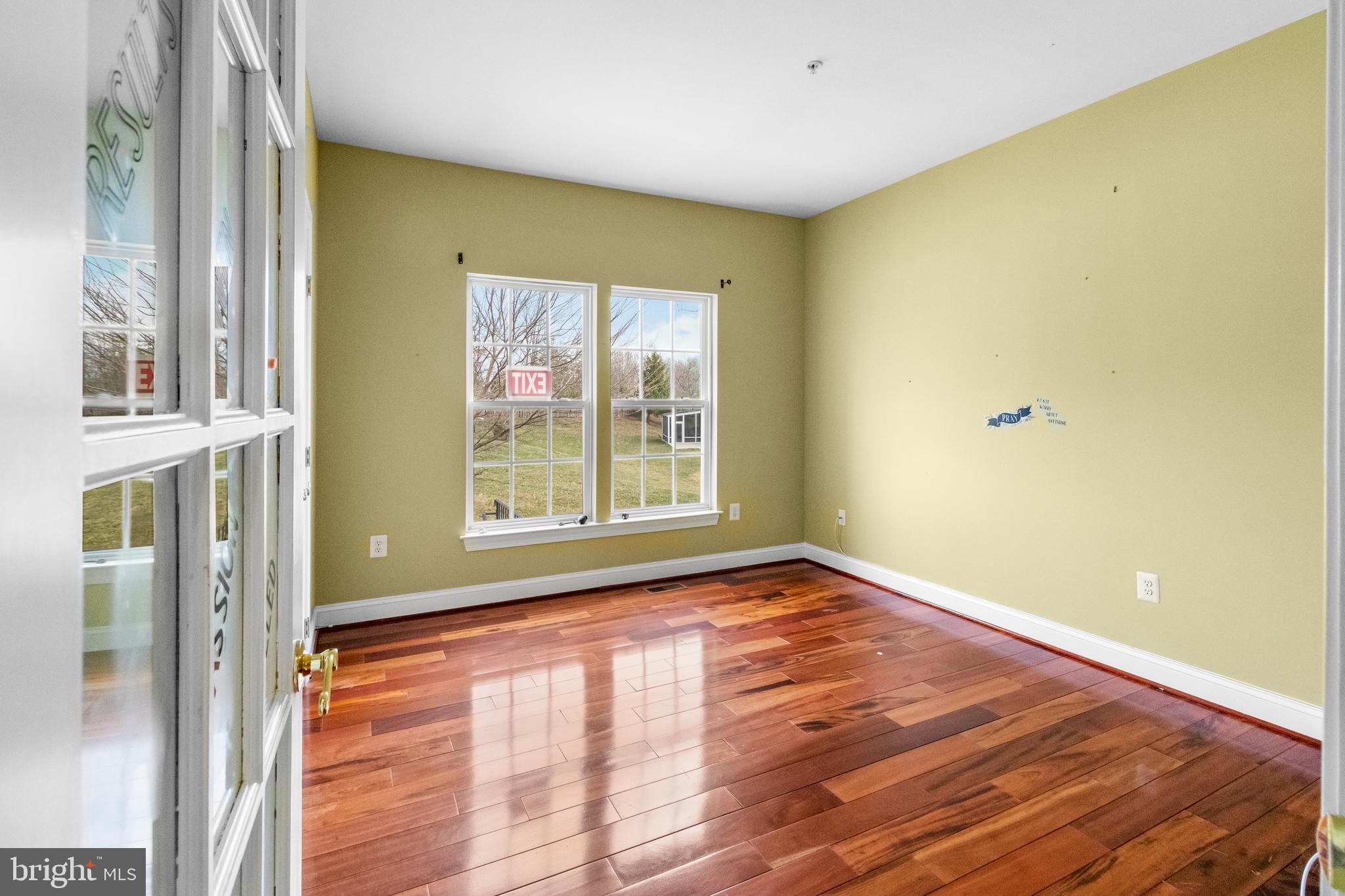 14107 Mintlaw Landing Laurel, MD 20707 - Photo 11 of 63 a view of an empty room with wooden floor and a window