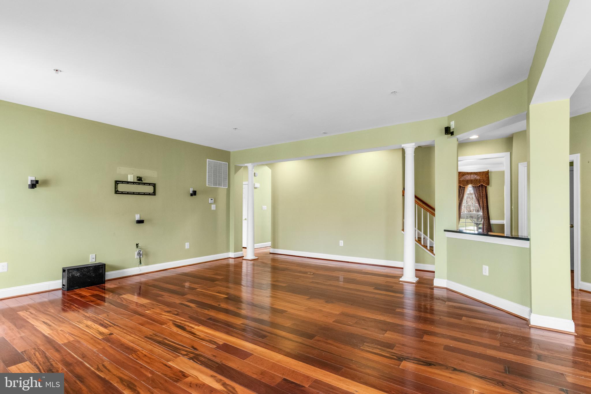 14107 Mintlaw Landing Laurel, MD 20707 - Photo 15 of 63 a view of a room with wooden floor and a ceiling fan