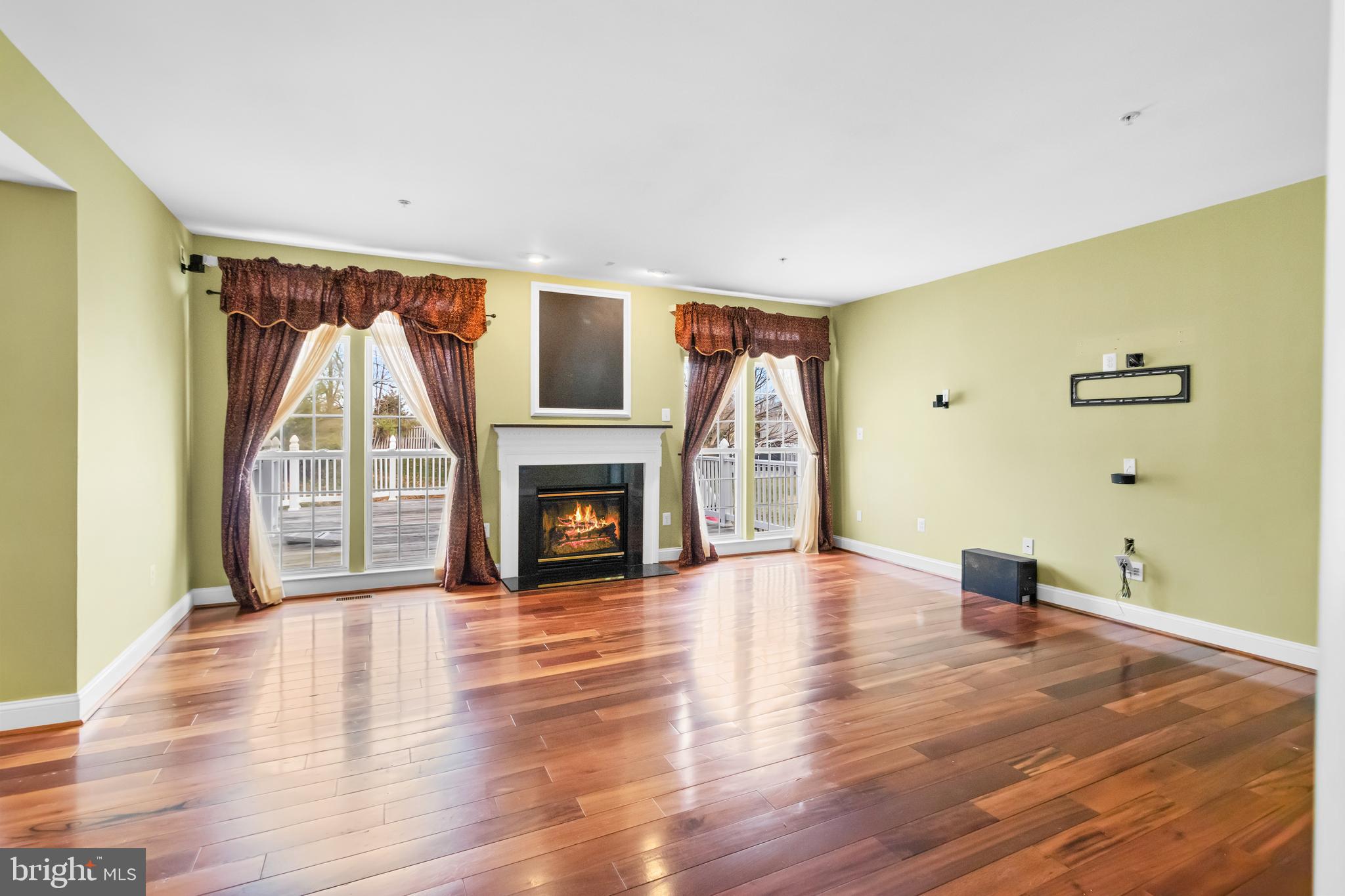 14107 Mintlaw Landing Laurel, MD 20707 - Photo 16 of 63 a view of empty room with wooden floor and fireplace