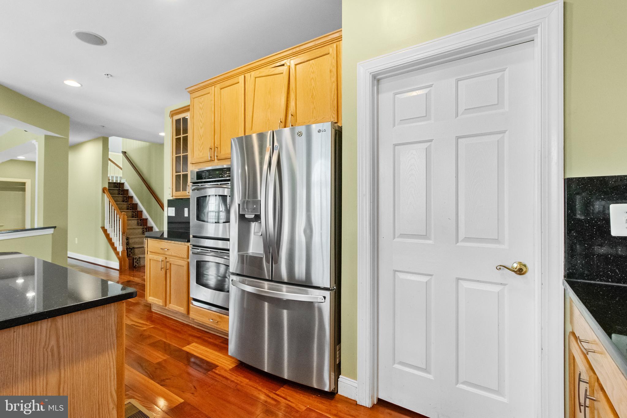 14107 Mintlaw Landing Laurel, MD 20707 - Photo 22 of 63 a view of a kitchen with wooden floor and electronic appliances