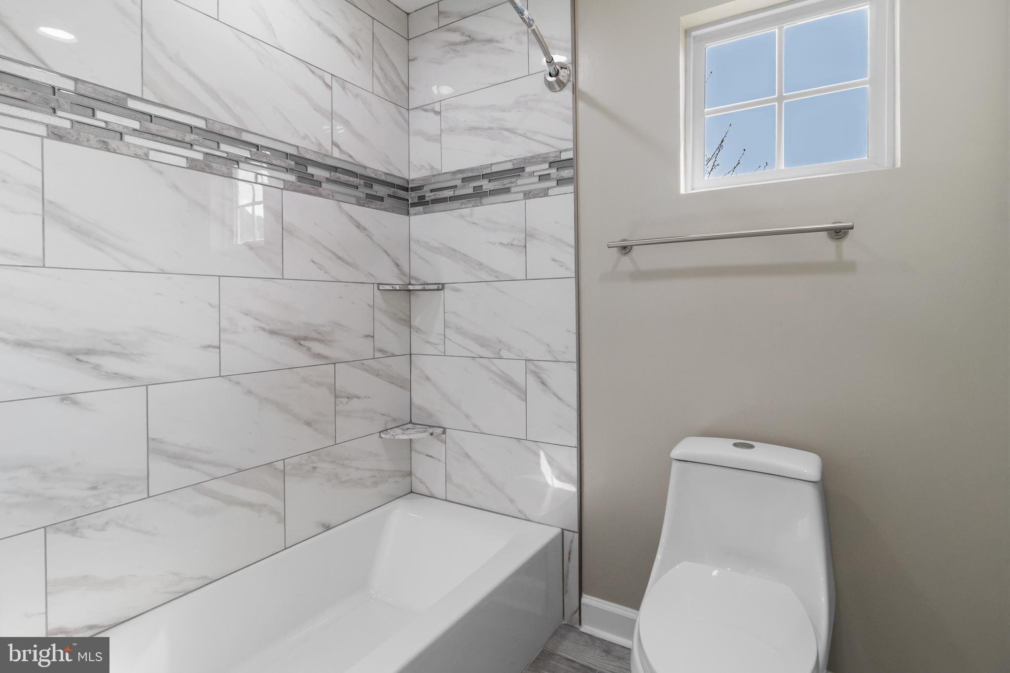 14107 Mintlaw Landing Laurel, MD 20707 - Photo 35 of 63 a bathroom with a toilet and shower