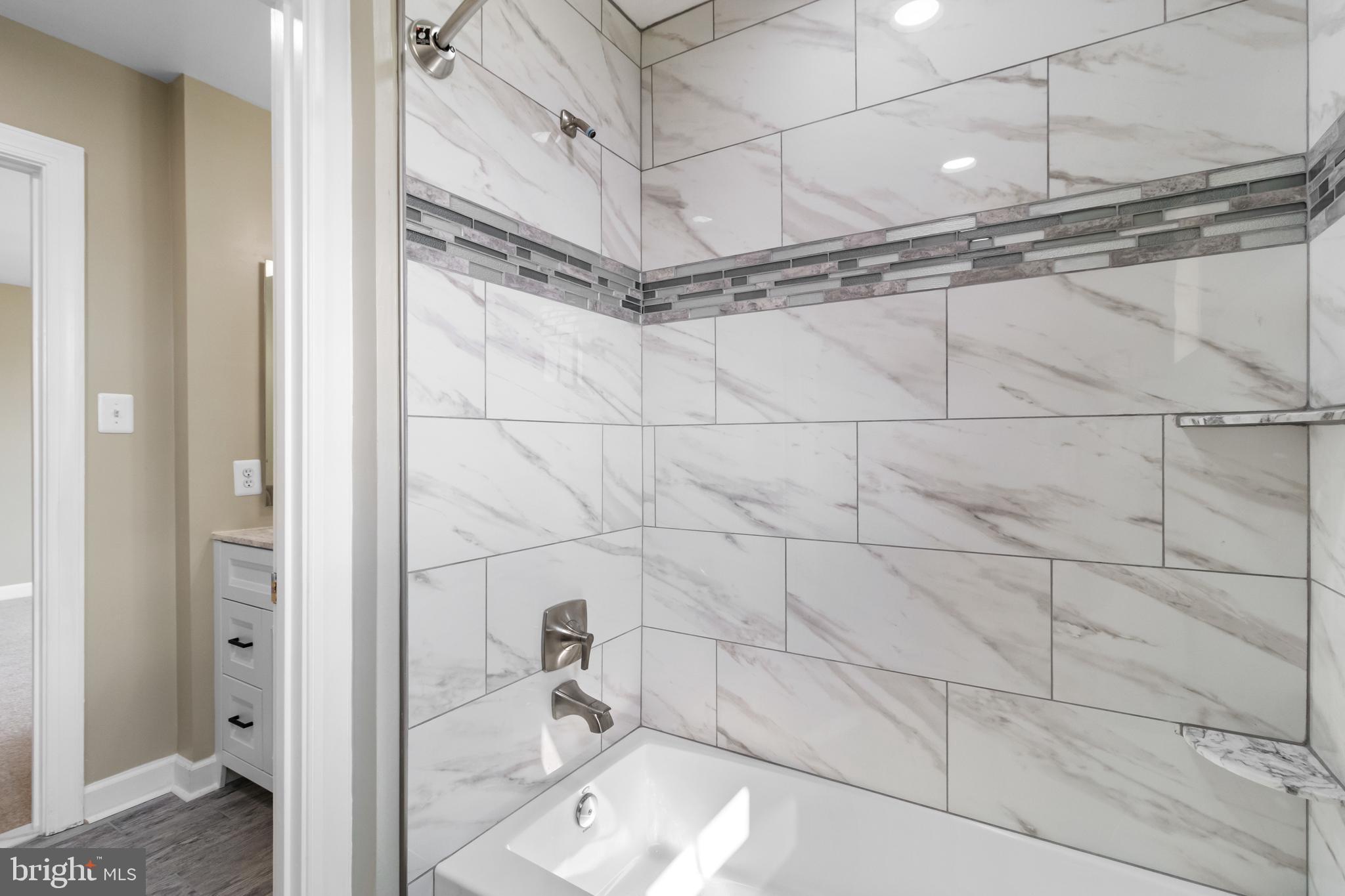 14107 Mintlaw Landing Laurel, MD 20707 - Photo 36 of 63 a bathroom with a sink and shower