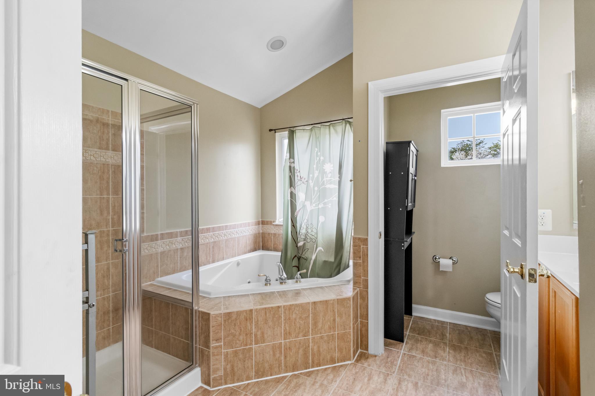 14107 Mintlaw Landing Laurel, MD 20707 - Photo 42 of 63 a bathroom with a tub and shower