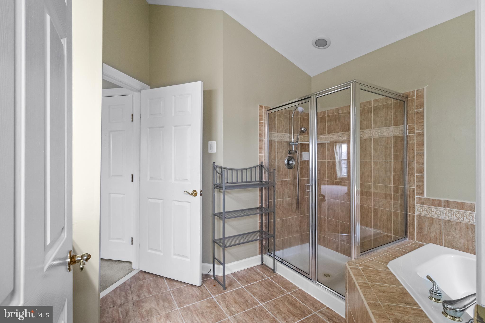 14107 Mintlaw Landing Laurel, MD 20707 - Photo 43 of 63 a bathroom with a glass shower door