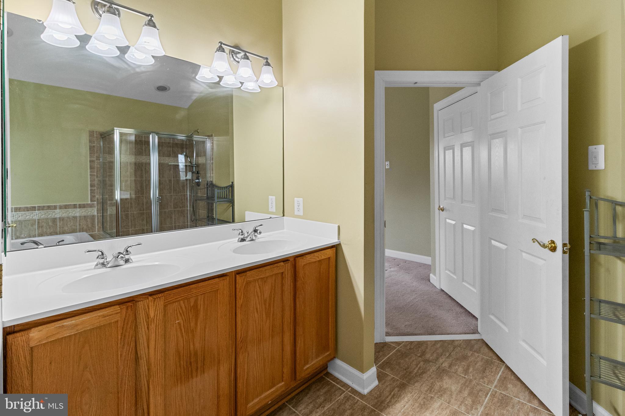 14107 Mintlaw Landing Laurel, MD 20707 - Photo 44 of 63 a bathroom with a sink double vanity and a mirror