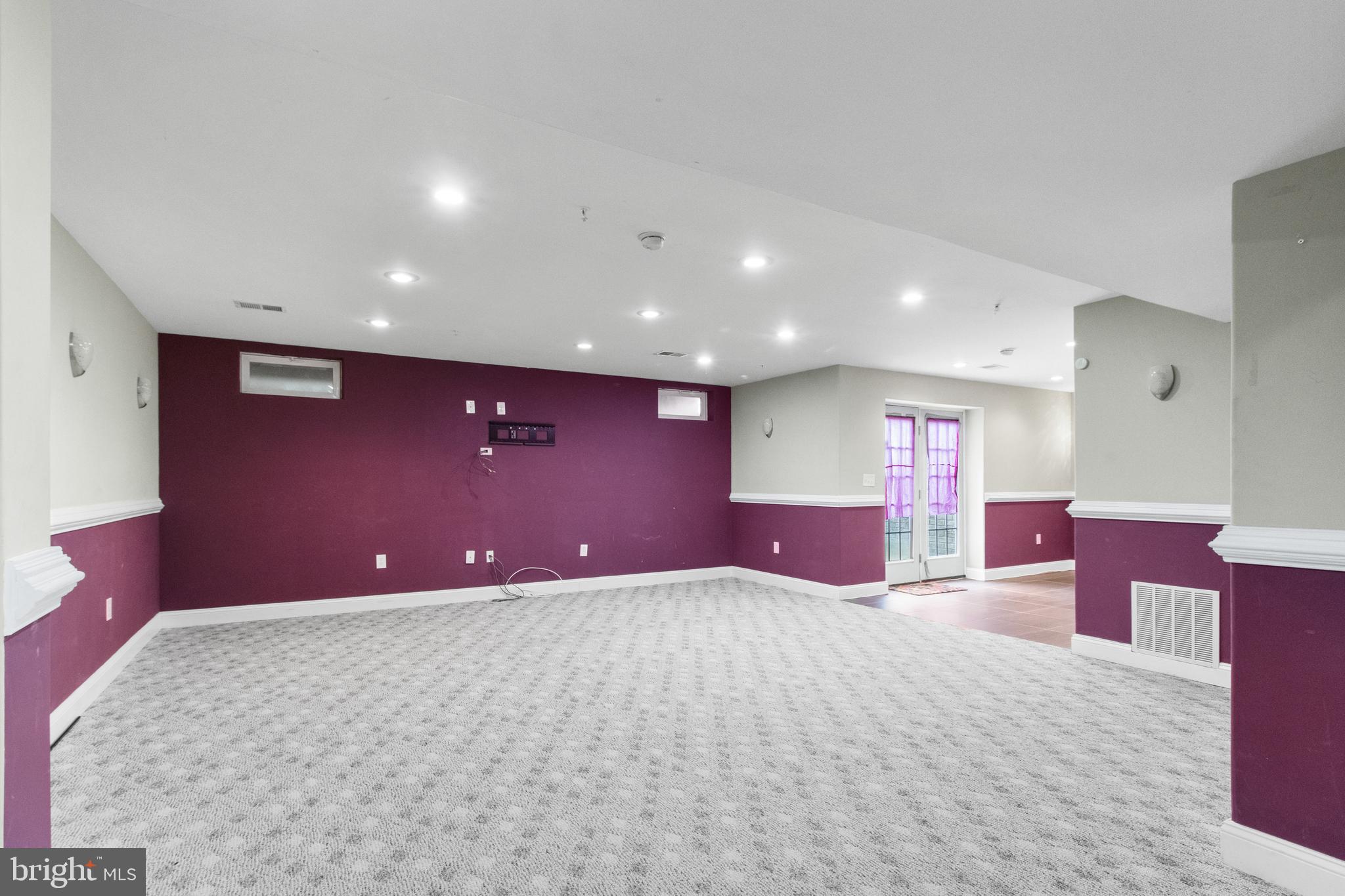14107 Mintlaw Landing Laurel, MD 20707 - Photo 50 of 63 a view of an empty room with a projector screen and windows