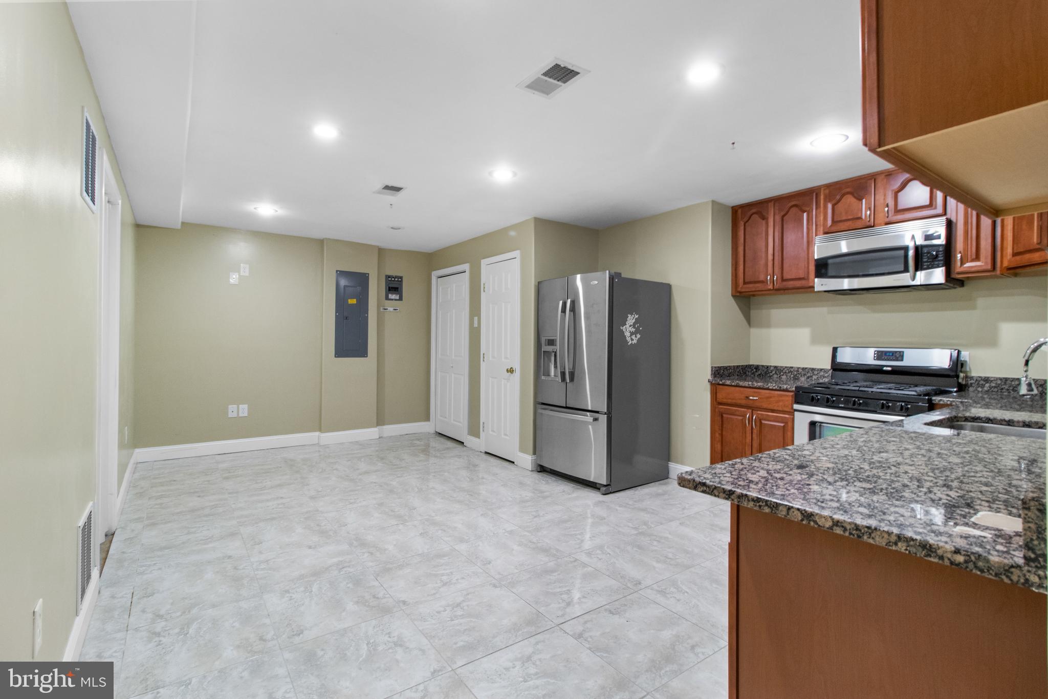 14107 Mintlaw Landing Laurel, MD 20707 - Photo 56 of 63 a kitchen with stainless steel appliances granite countertop a refrigerator a stove and a sink