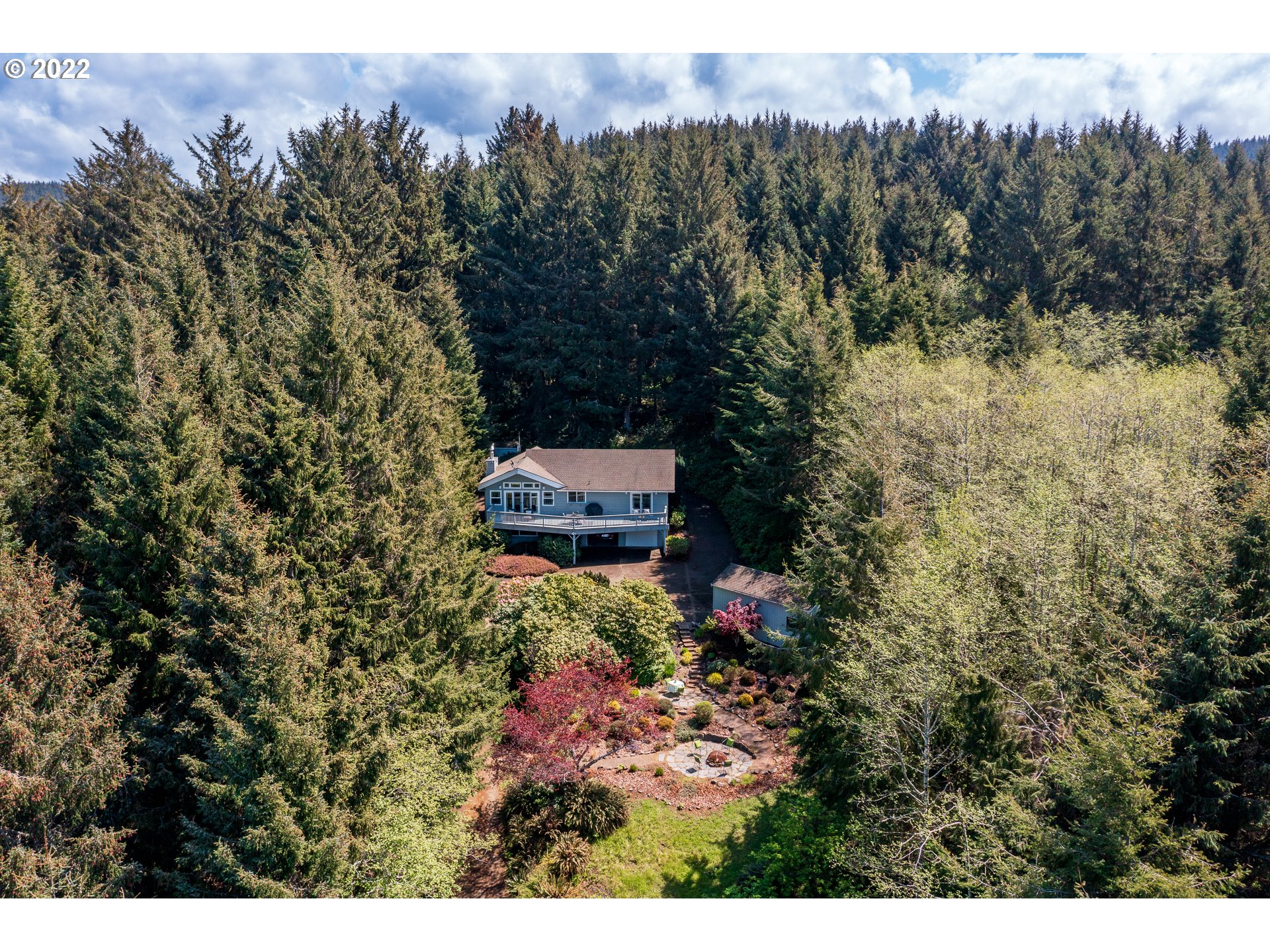 3096 Northeast East Line Road Yachats, OR 97498 - Photo 1 of 30 a view of a house with a yard and tree