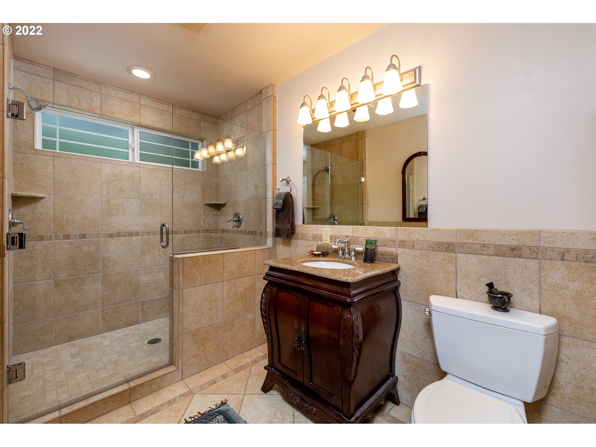 3096 Northeast East Line Road Yachats, OR 97498 - Photo 21 of 30 a bathroom with a sink a toilet a mirror and shower