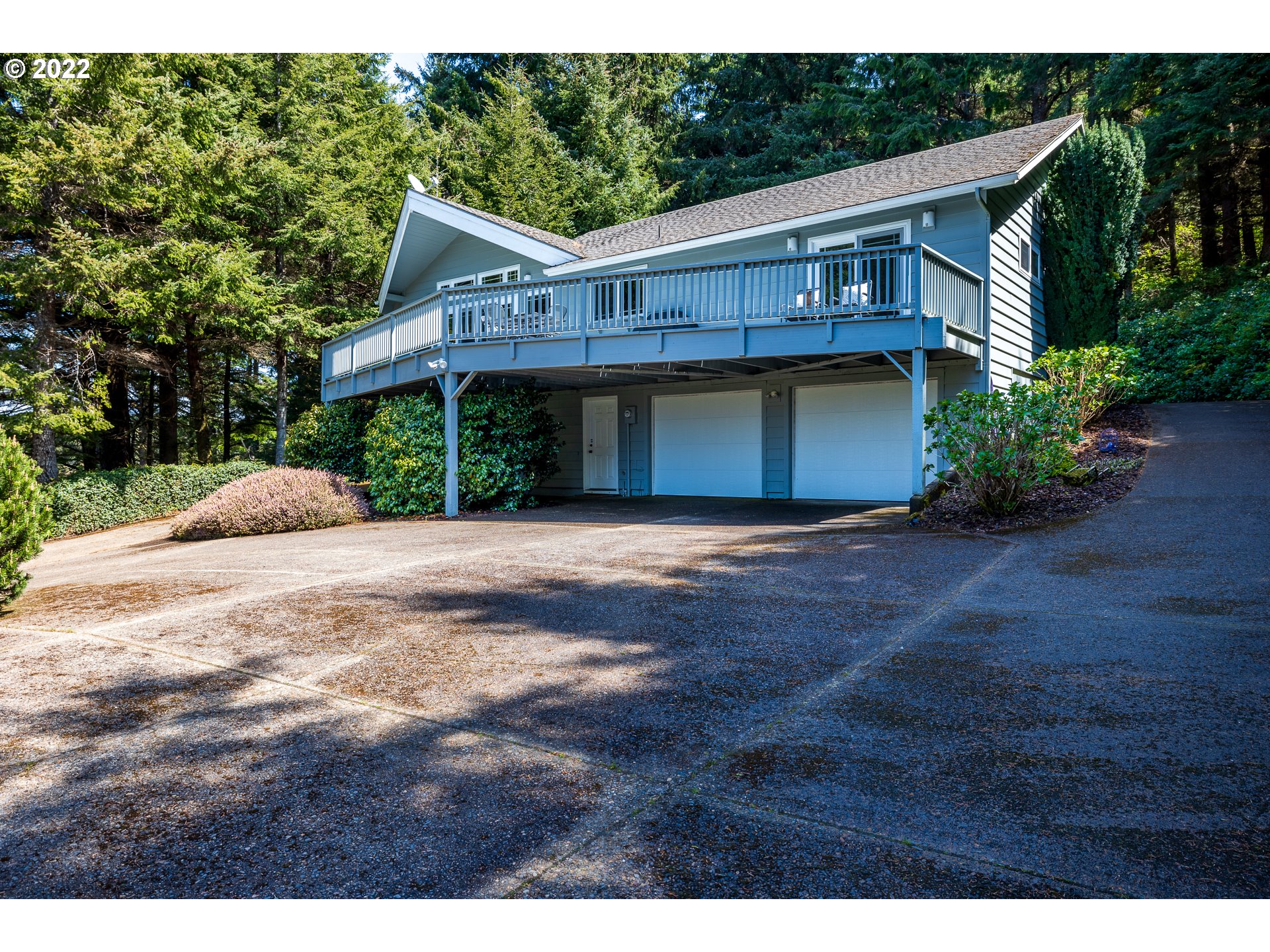 3096 Northeast East Line Road Yachats, OR 97498 - Photo 3 of 30 a front view of a house with a garden