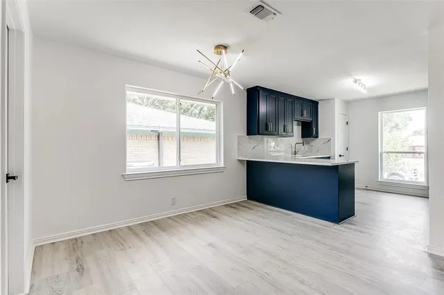 a kitchen with kitchen island granite countertop a stove and a sink