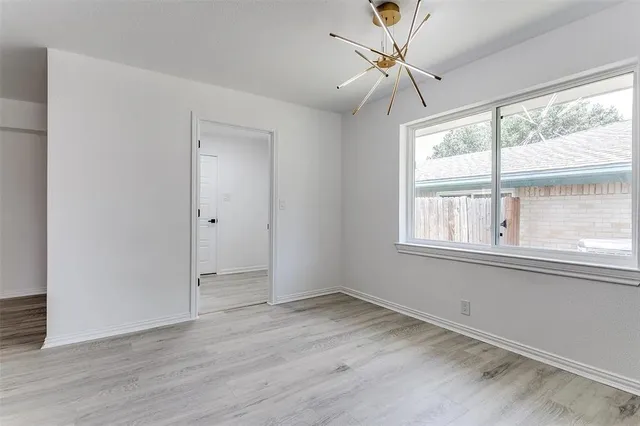 a view of a livingroom with a window and wooden floor