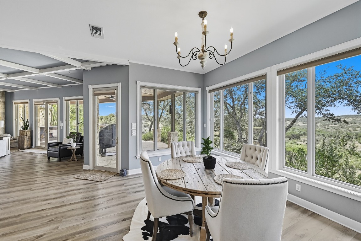 a view of a dining room with furniture wooden floor and chandelier