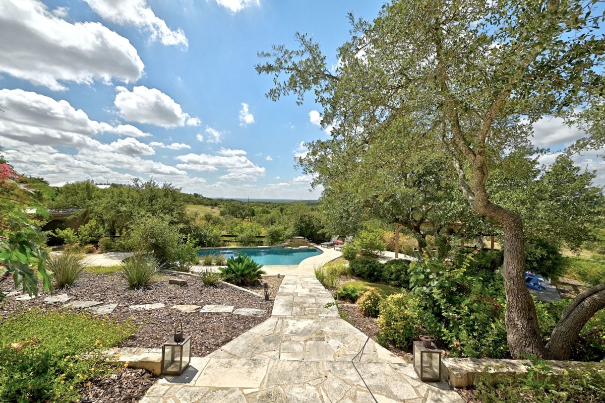 Outdoor pool featuring a patio looking out to sweeping hill country views