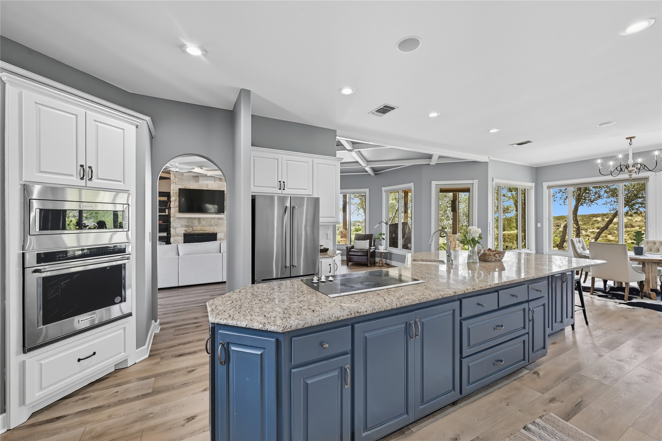 8075 Mt Sharp Road Wimberley, TX 78676 - Photo 9 of 30 a large kitchen with granite countertop a large counter top stainless steel appliances and cabinets