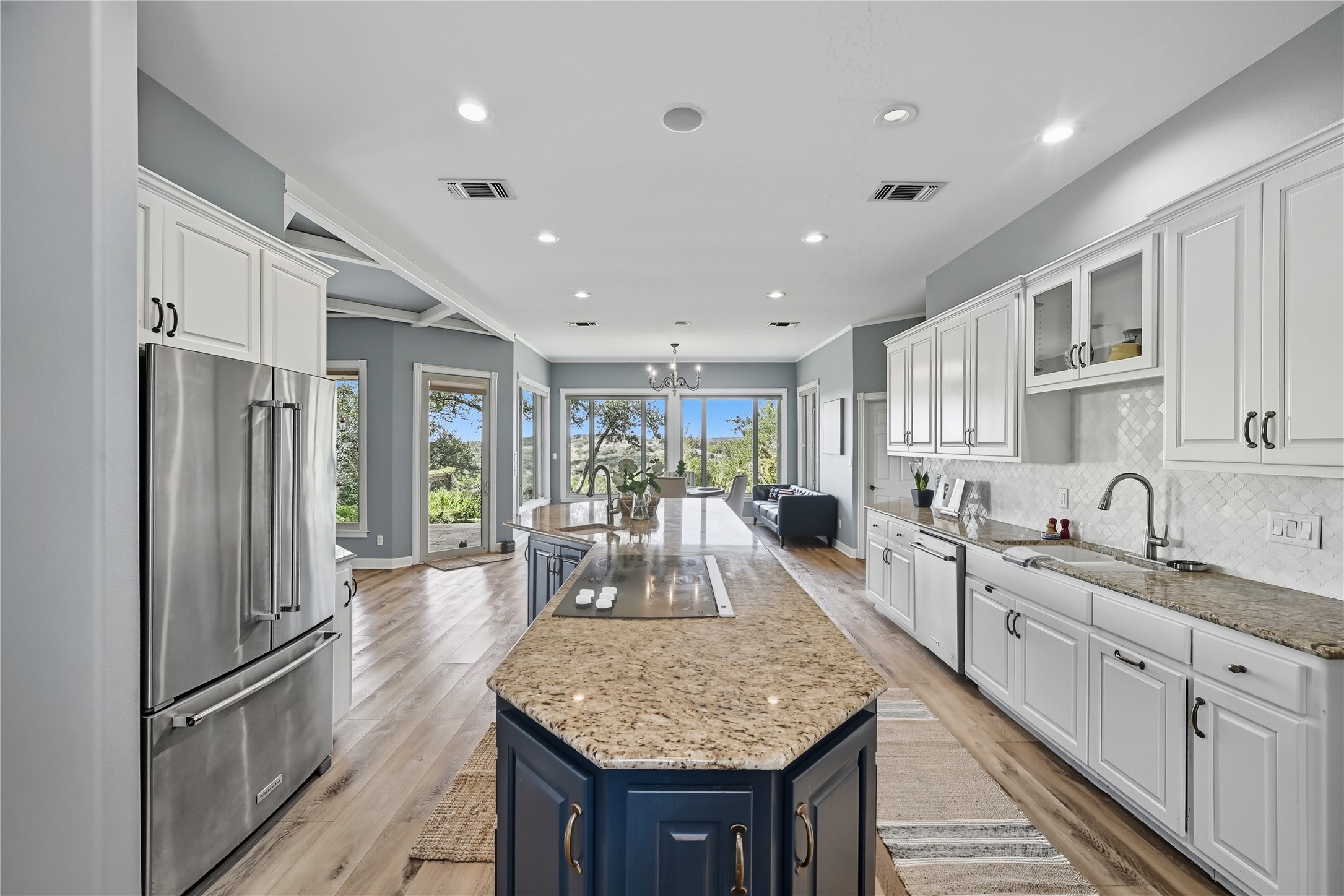8075 Mt Sharp Road Wimberley, TX 78676 - Photo 11 of 30 a kitchen with granite countertop center island stainless steel appliances furniture cabinets and a counter top space