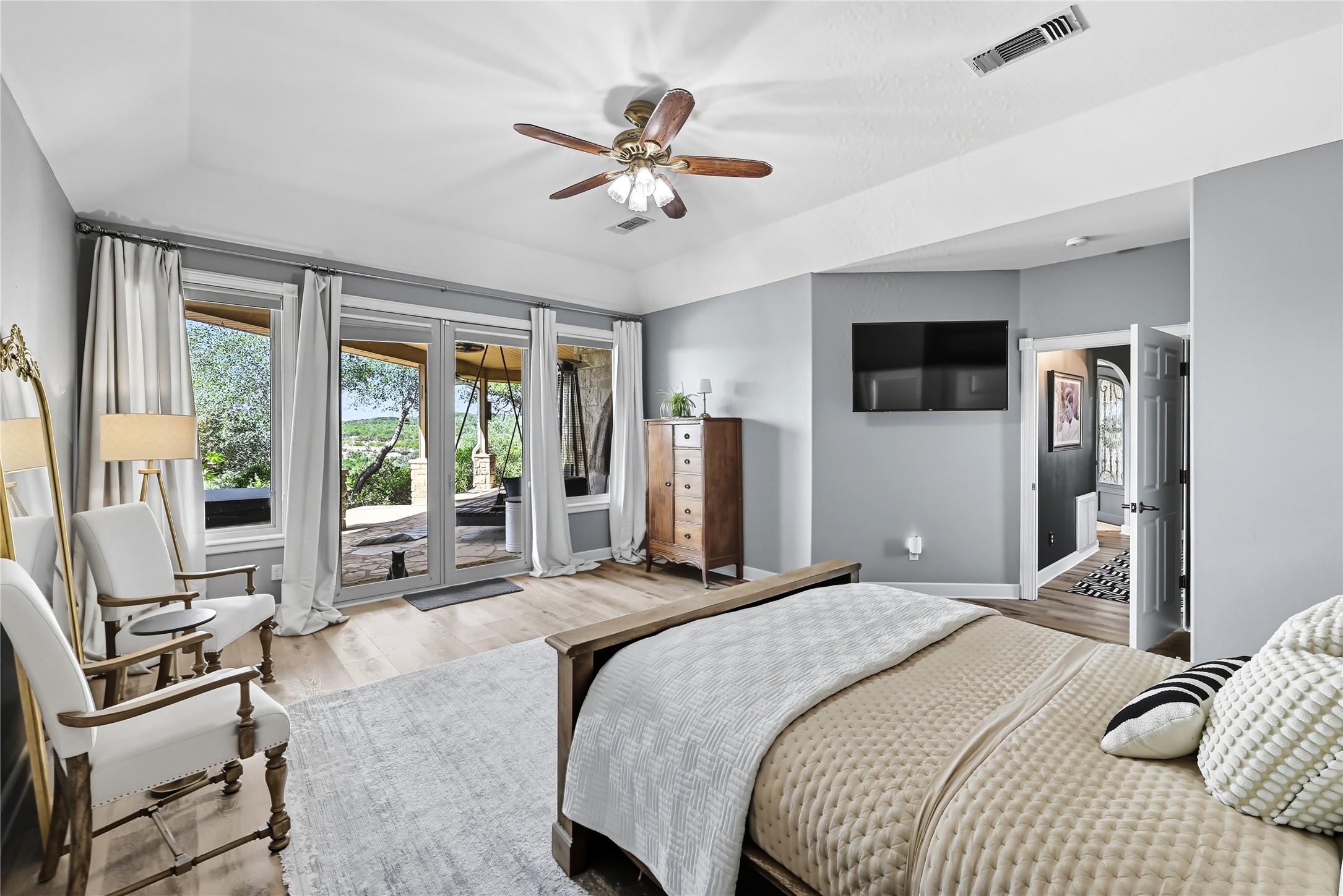 8075 Mt Sharp Road Wimberley, TX 78676 - Photo 15 of 30 a bedroom with a bed a flat screen tv and a large window