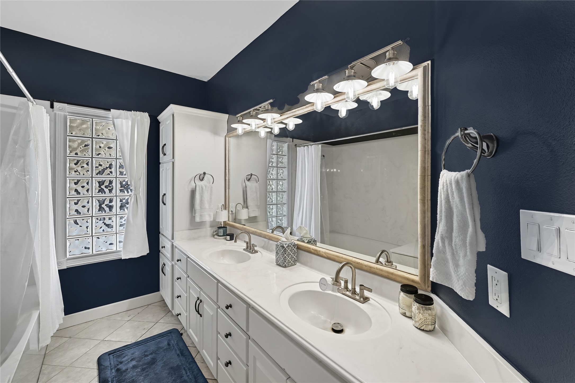 8075 Mt Sharp Road Wimberley, TX 78676 - Photo 17 of 30 a bathroom with a double vanity sink and a mirror