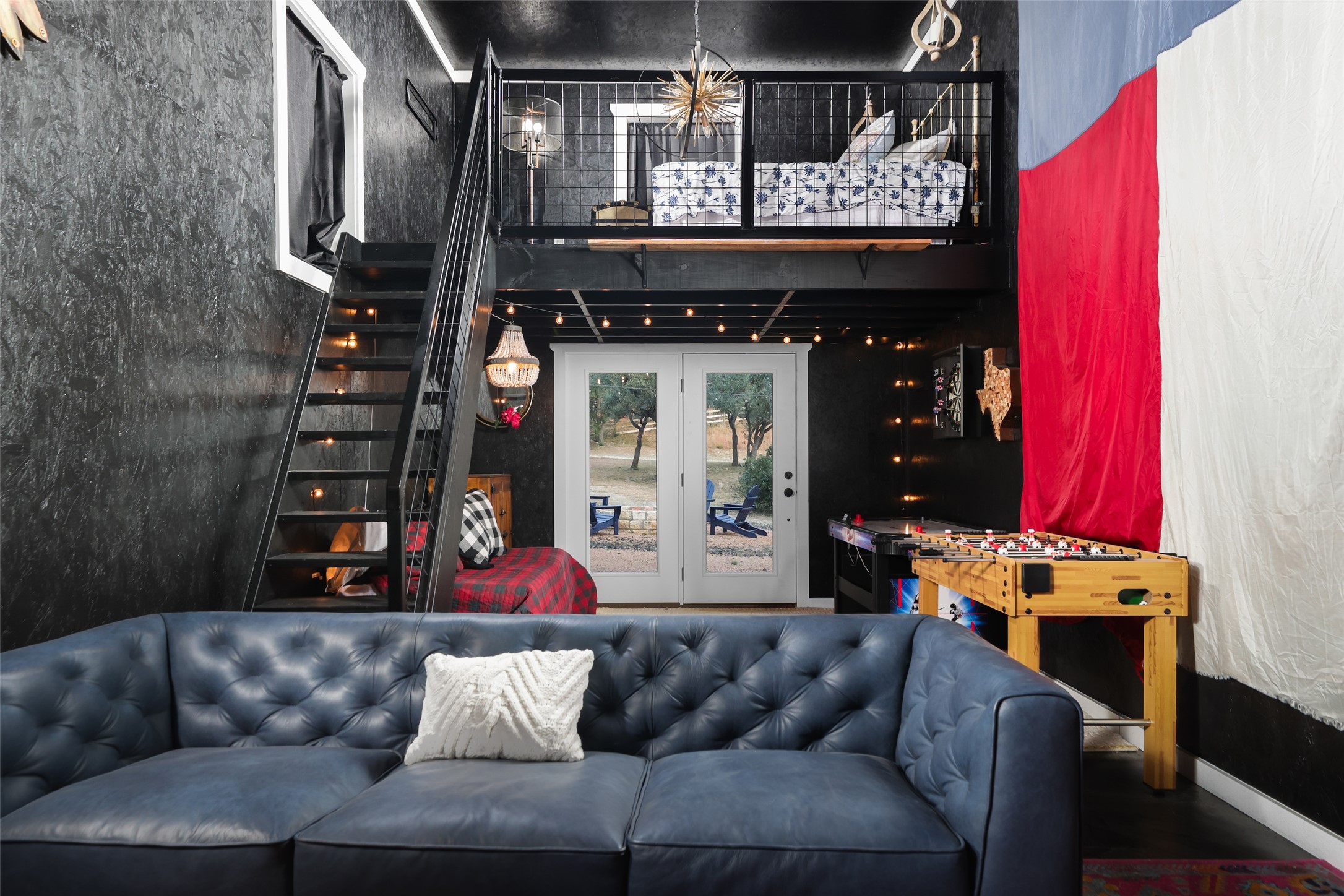 8075 Mt Sharp Road Wimberley, TX 78676 - Photo 23 of 30 a living room with furniture and a chandelier