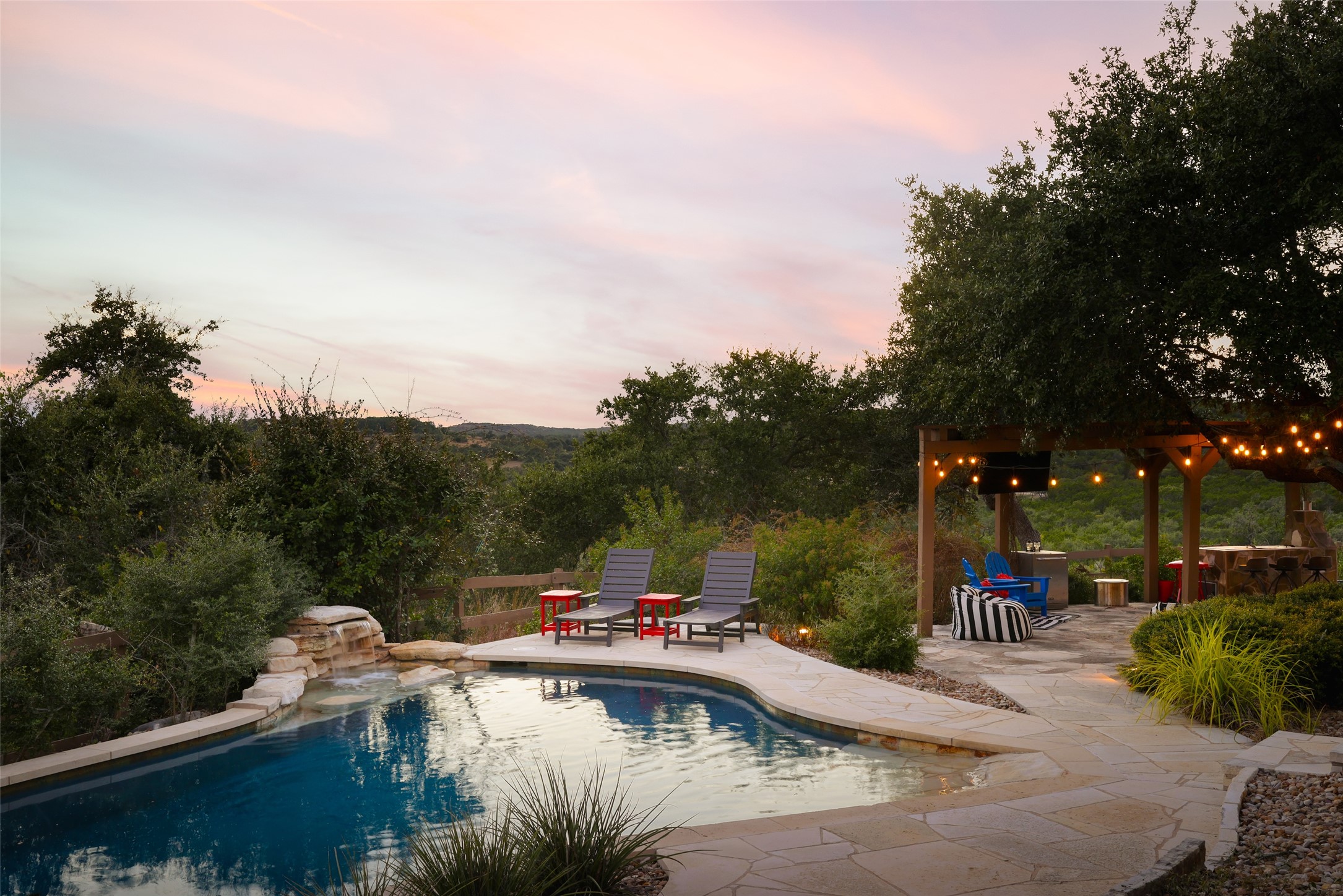 8075 Mt Sharp Road Wimberley, TX 78676 - Photo 27 of 30 a view of swimming pool with a table and chairs under an umbrella