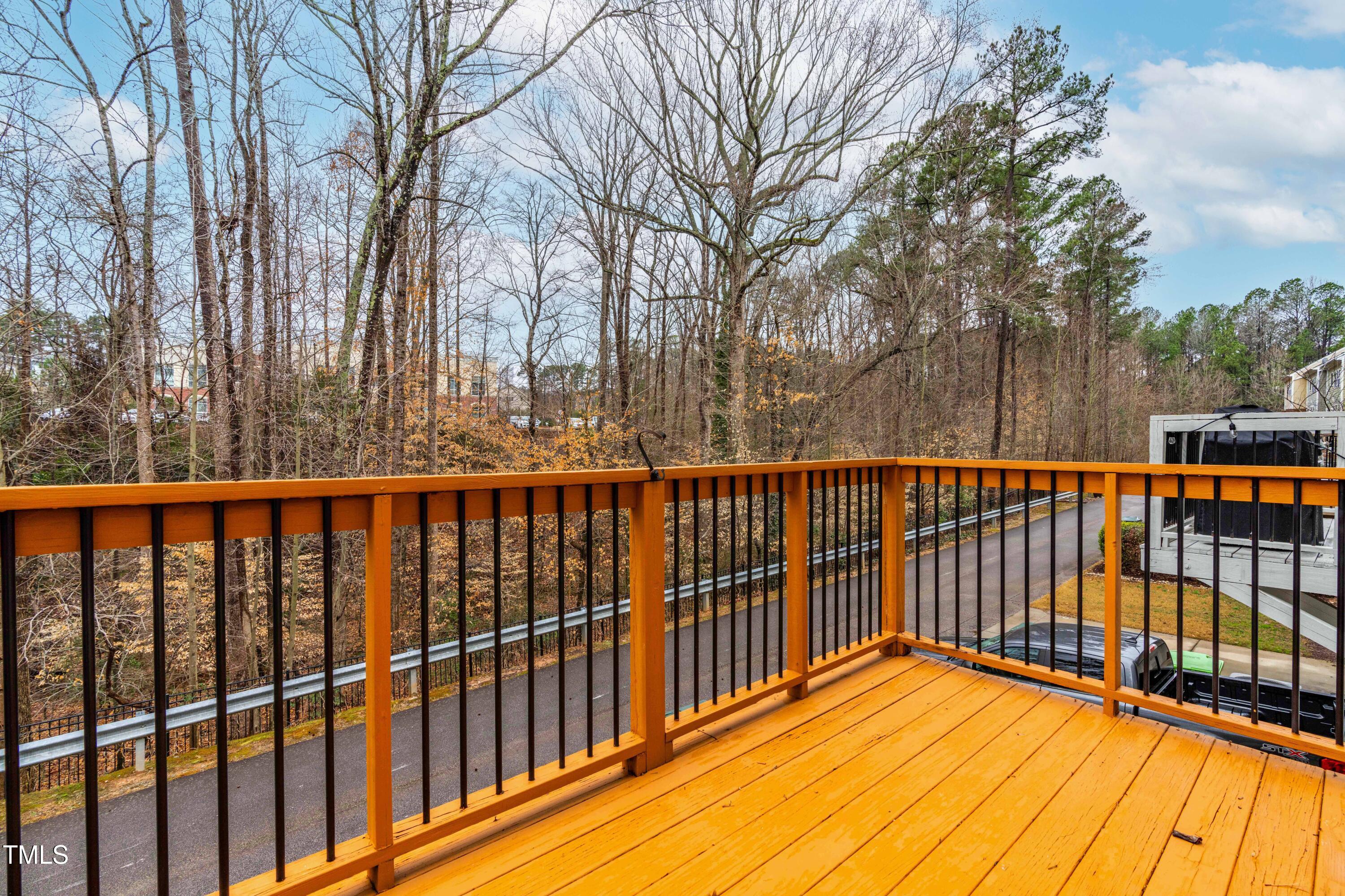 5633 Wade Park Boulevard Raleigh, NC 27607 - Photo 8 of 34 a view of balcony with wooden floor and fence