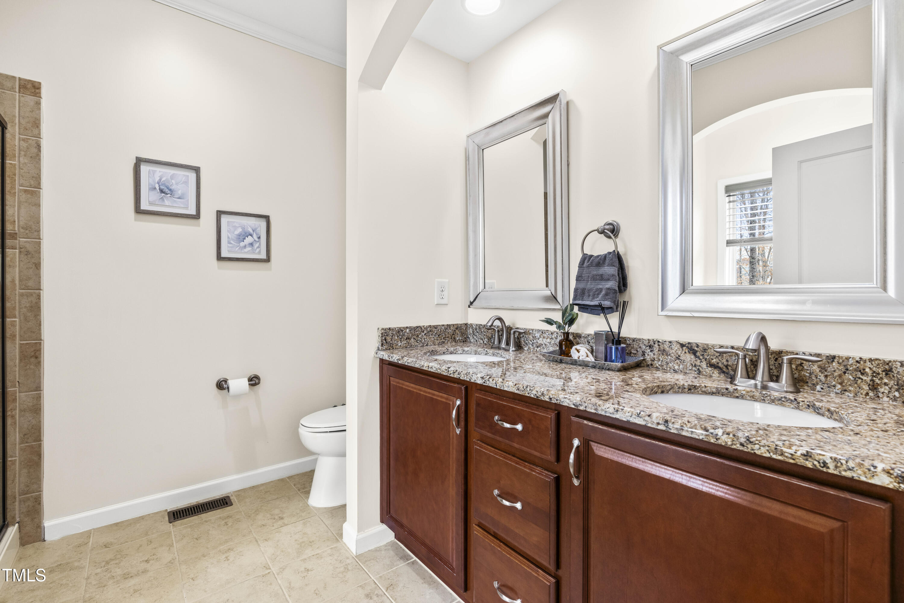 5633 Wade Park Boulevard Raleigh, NC 27607 - Photo 25 of 34 a bathroom with a granite countertop toilet sink and mirror