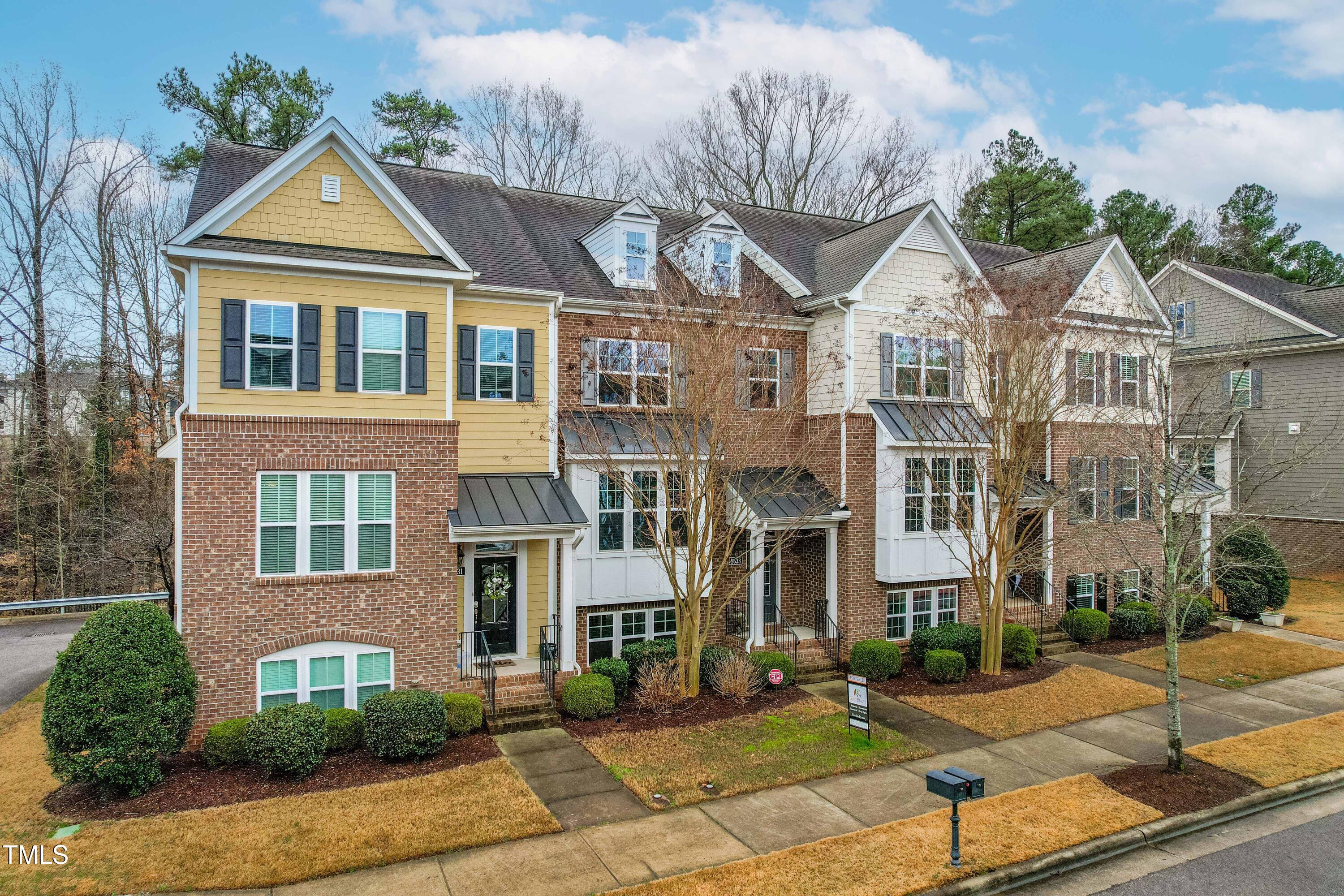 5633 Wade Park Boulevard Raleigh, NC 27607 - Photo 2 of 34 a view of a brick building next to a yard