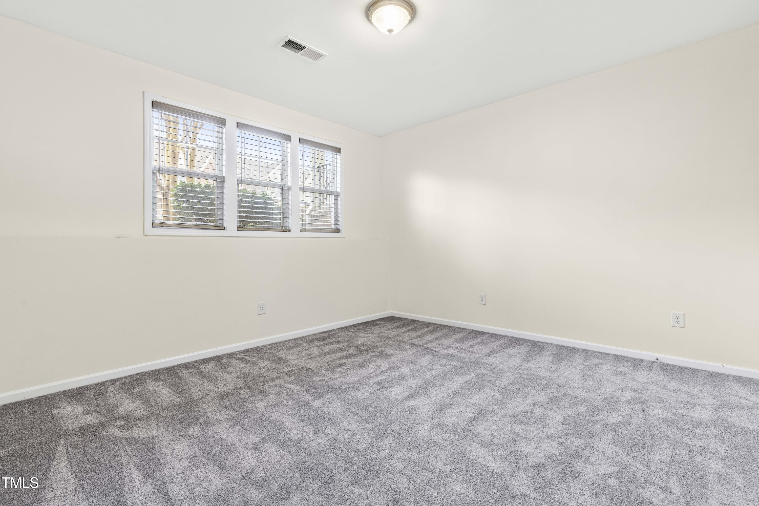 5633 Wade Park Boulevard Raleigh, NC 27607 - Photo 30 of 34 an empty room with windows