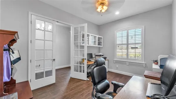 a workspace with wooden floor and a window