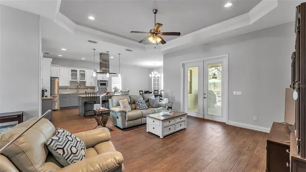 a living room with furniture or wooden floor and a chandelier